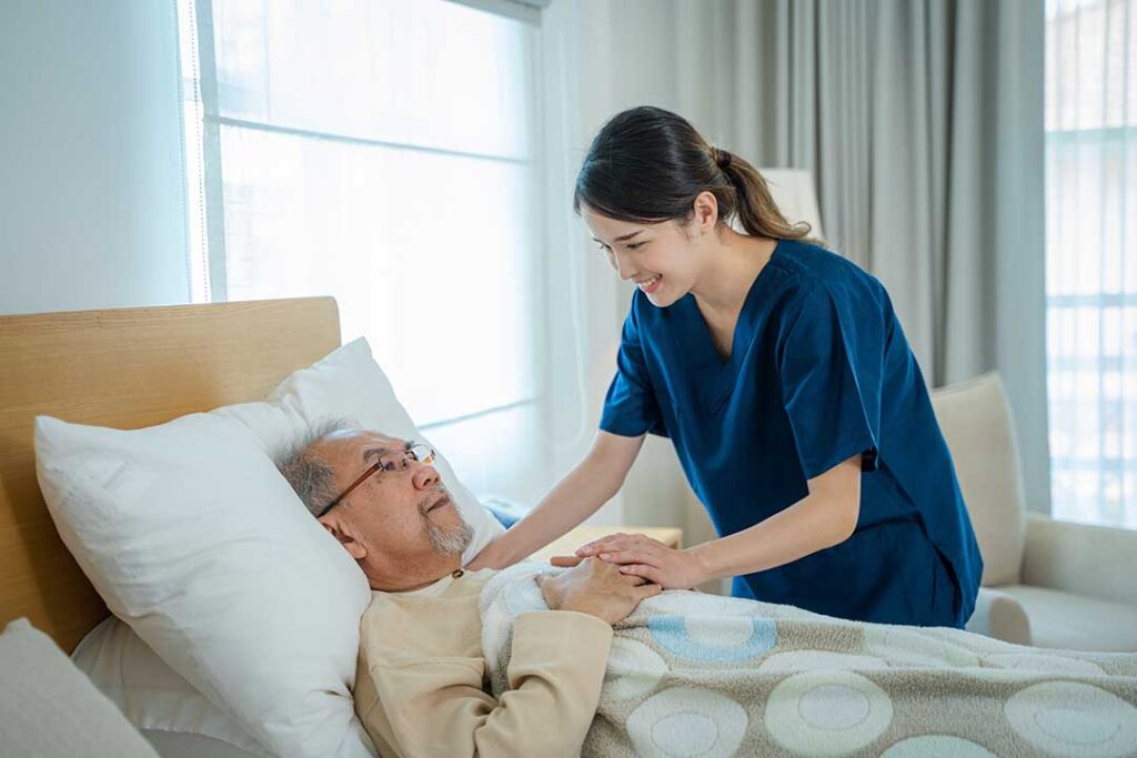 An older adult and caregiver sharing an activity together in a comfortable, home-like setting.